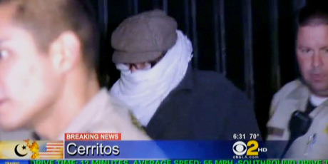 In this image from video provided by CBS2-KCAL9, Nakoula Basseley Nakoula, is escorted by LA County sheriff's deputies out of his house and into hiding. Photo / AP