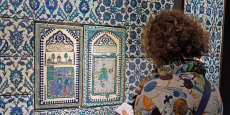 A member of the media examines a ceramic tile wall displayed in the new Islamic art section of the Louvre museum in Paris. Photo / AP