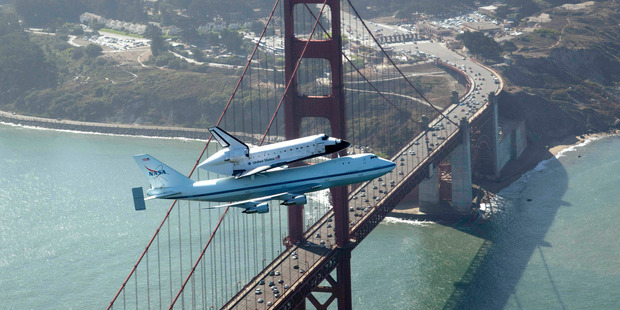 Space shuttle Endeavour and its 747 carrier aircraft soar over the Golden Gate Bridge in San Francisco. Photo / AP