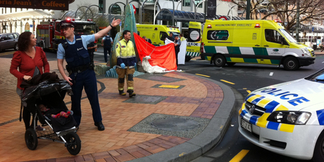 Police and ambulance crews at the scene where a woman died following a fall in central Wellington this morning. Photo / APNZ