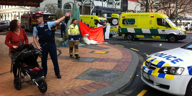 Police and ambulance crews at the scene where a woman died following a fall in central Wellington this morning. Photo / APNZ