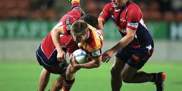 Piers Francis of Waikato is tackled by Peter Betham, left, and Kieron Fonotia of Tasman. Photo / Getty Images