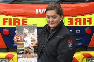 Kawakawa firefighter and reluctant pin-up girl Kahlia Scott with the latest New Zealand firefighters calendar. Photo / Supplied
