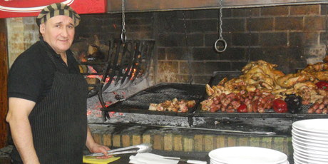 Rib-eye steak, sirloin, rump, offal, sausage and chickens are all piled high on an Argentinian Parilla. Photo / James Ihaka