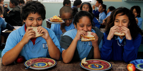 Pupils (from left) Oshiana Papara, 12, Beyna Simon, 11, and Te Pare Kelly, 11, enjoy the lunch provided by Te Wharekura O Te Kaokaoroa O Patetere school in Putaruru. Photo / Christine Cornege