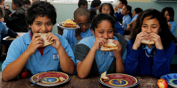 Pupils (from left) Oshiana Papara, 12, Beyna Simon, 11, and Te Pare Kelly, 11, enjoy the lunch provided by Te Wharekura O Te Kaokaoroa O Patetere school in Putaruru. Photo / Christine Cornege