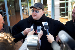 Kim Dotcom speaks to the media outside the High Court. Photo / Sarah Ivey
