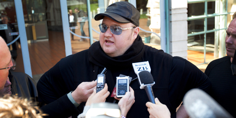 Kim Dotcom speaks to the media outside the High Court at Auckland yesterday afternoon. Photo / Sarah Ivey