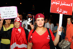 Tunisian women carry placards protesting their rights which read: 'no future for Tunisia without women' and right, 'equal rights for men and women'. Photo / AP