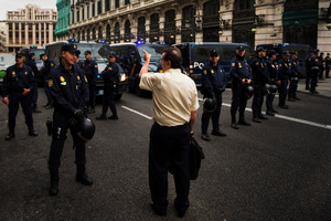 Every route around Spain's Parliament is guarded as thousands take to the streets to protest against Government spending cuts affecting pensions, wages, and retirement ages.