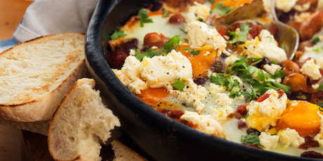 Baked eggs and chilli beans with creamed lemon feta. Photo / Babiche Martens