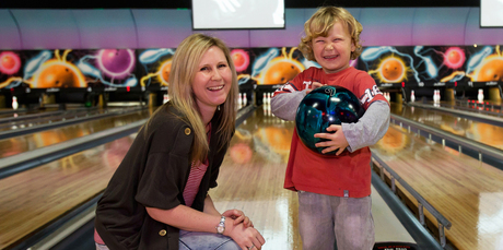Rachel Grunwell and her son, Lachlan Buckley, 5, swap bowling tips at Pins Lincoln in Henderson. Photo / Getty Images