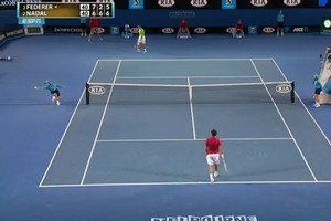 A ball boy catches a ball hit to him by Roger Federer. Photo / YouTube