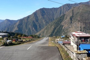 Landing or taking off from Lukla Airport in Nepal is a nail-biting experience, with a cliff at the end of the runway. Photo / Jim Eagles