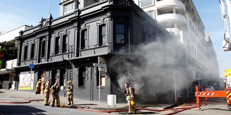 Smoke billows from the ground floor of the Backbencher pub in Wellington after a fire sparked by workmen with a welder. Photo / Mark Mitchell