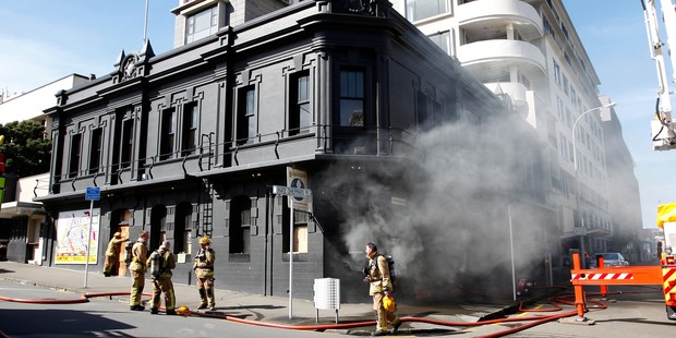Smoke billows from the ground floor of the Backbencher pub in Wellington after a fire sparked by workmen with a welder. Photo / Mark Mitchell