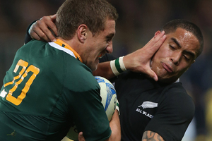 Johan Goosen of South Africa fends off Aaron Smith of the All Blacks during the Rugby Championship. Photo / Getty Images.