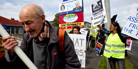 Tim Birch joined about 60 protestors as they marched in West Auckland today to protest over welfare reforms. Photo / Dean Purcell