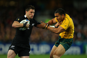 Cory Jane of the All Blacks hands off Digby Ioane of the Wallabies. Photo / Getty Images