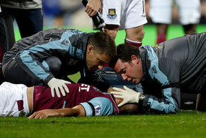 West Ham United's Winston Reid lies on the ground as he is attended to by medics, as his team plays Queens Park Rangers during their English Premier League soccer match. Photo / AP