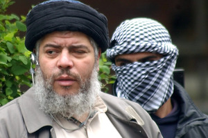 Muslim cleric Abu Hamza al-Masri, with a masked bodyguard. File Photo / AP
