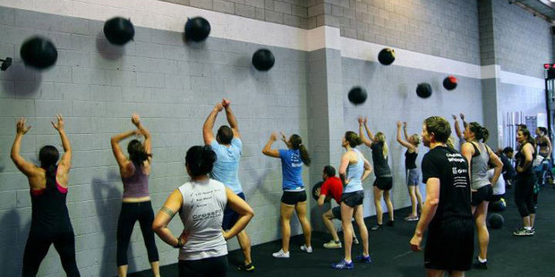 CrossFit gyms pride themselves on devising fresh training methods like throwing weighted bags against a wall. Photo / Supplied