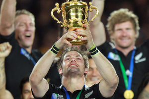 All Black captain Richie McCaw holding Web Ellis trophy aloft. Photo / Doug Sherring