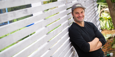 Justin Newcombe with his DIY fence. Photo / Richard Robinson