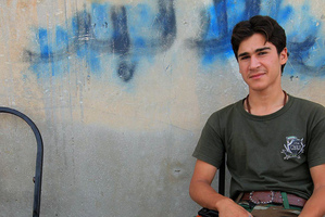 A Syrian rebel sits with his weapon on his knee in the rebel-held town of Tel Abyad. Photo / AP