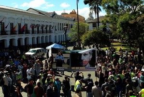 Demonstrators gather around a large picture of WikiLeaks founder Julian Assange in Ecuador. Photo / AP