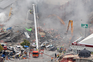 Emergency service staff hunting for survivors amongst the rubble of the CTV Building. Photo / Mark Mitchell