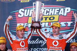 Paul Dumbrell and Jamie Whincup drivers of the #1 Team Vodafone Holden hold aloft the Peter Brock Trophy after winning the Bathurst 1000. Photo / Getty Images.