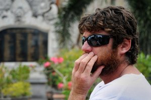 Australian Lee Harrison visits the memorial site for the Bali bombing victims to search for the name of his sister who was killed.Photo / AFP