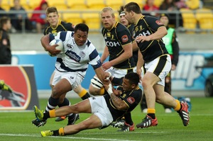 Pauliasi Manu of Auckland is tackled by Wellington's Frae Wilson. Photo / Getty Images