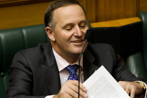 Prime Minister John Key takes his seat after reading his statement to the House, correcting what he said about the GCSB's involvement with Kim Dotcom. Photo / Mark Mitchell.