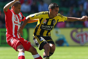Luke Rowe of the Phoenix is challenged by Fred of the Heart during the round two A-League match between the Melbourne Heart and the Wellington Phoenix. Photo / Getty Images.