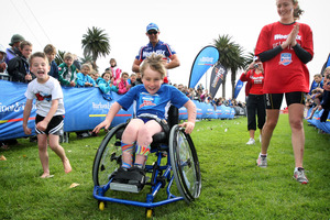 8-year-old Jaden Movold is cheered on to the finish line. Photo / Natalie Slade