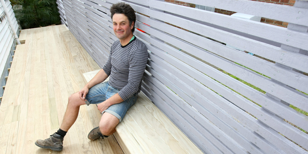 Justin Newcombe with the finished summer storage box/seat. Photo / Chris Gorman