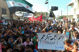 Anti-Syrian regime protesters wave the Syrian revolution flag at Sarmad, northern Syria. Photo / AP