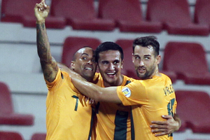 Tim Cahill, centre, celebrates after scoring against Iraq. Photo / AP