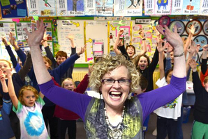 Winner of this year's most inspiring teacher award Jan Stevens celebrates with pupils from the soon-to-be-closed Rotary Park School. Photo / Peter McIntosh