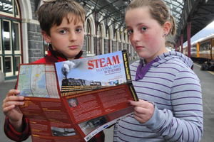 Hamish (9) and Kathryn (11) Milne, of Dunedin, wait in vain for the Ka 942 steam engine at Dunedin Railway Station. Photo / Craig Baxter.