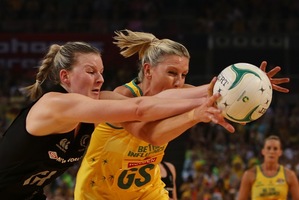 Catherine Cox of Australia and Katrina Grant of the Silver Ferns compete for the ball. Photo / Getty Images