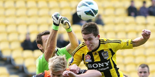 Louis Fenton of the Phoenix competes for the ball with Ben Halloran and Michael Theo of the Roar. Photo / Getty Images