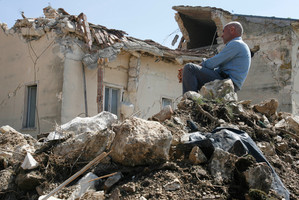 A man sits on rubble in the village of Onna, a day after a powerful earthquake struck the Abruzzo region in central Italy. Photo / AP