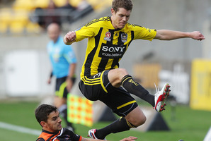 Tony Lochhead is tackled by the Roar's Jack Hingert. Photo / Getty Images