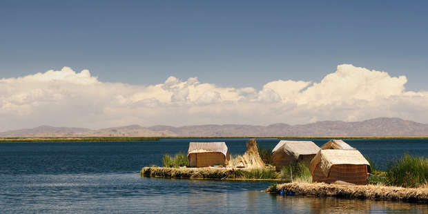 Uros Island locals get around the lake on boats made of totara reed, a material they also use to build their houses. Photo / Getty Images