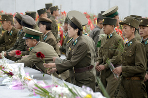 North Korean soldiers offer flowers in front of the statues of the country's founding ruler Kim Il Sung. Photo / AP
