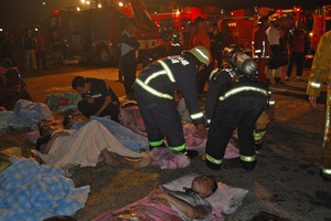 Fire rescue teams tend to patients for smoke inhalation after an early morning fire swept through the Hsinying Hospital's nursing ward. Photo / AP