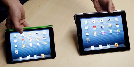 The iPad Mini, at left, is shown next to the 4th Generation iPad. Photo / AP